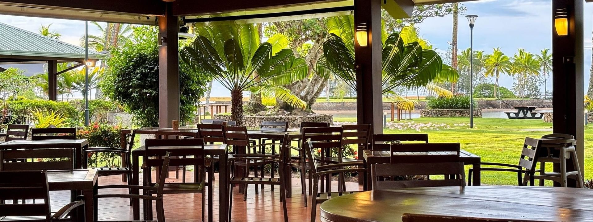 Empty tables and chairs inside Grill restaurant at The Naviti Resort in Korolevu