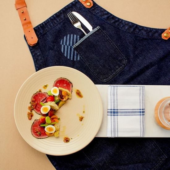 Meals served on plate with apron design on background at Pullman Albert Park