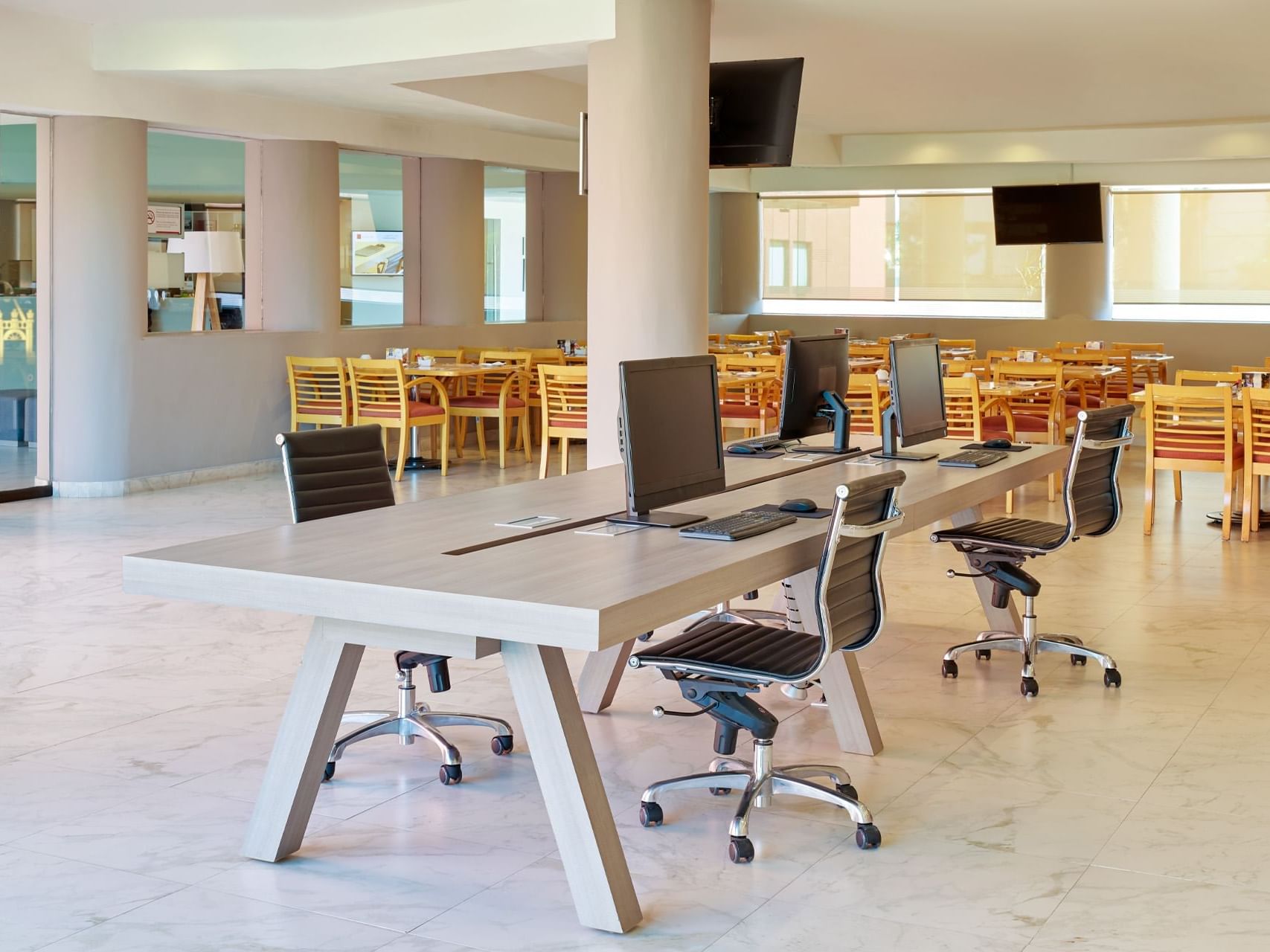 Workstation next to a dining area of a restaurant at Fiesta Inn