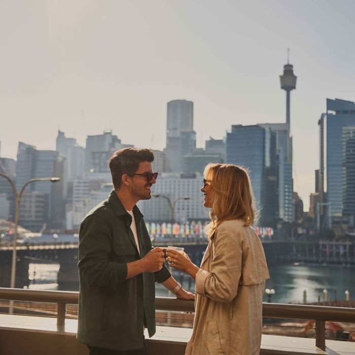Couple enjoying sunset drinks on ibis bar deck