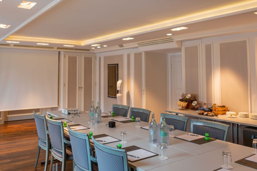 Table served with notebooks and water at Salon Merkur at Hotel Palace Munich