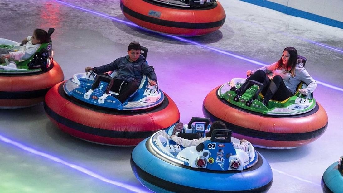 People riding vibrant bumper cars on an ice rink at Ice Zoo Alexandria, near Novotel Sydney International Airport