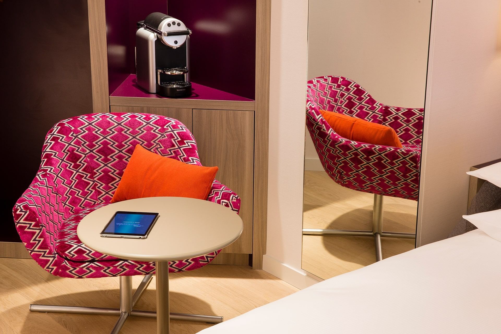 Mirror, chair & stool in a room at Oceania Rennes