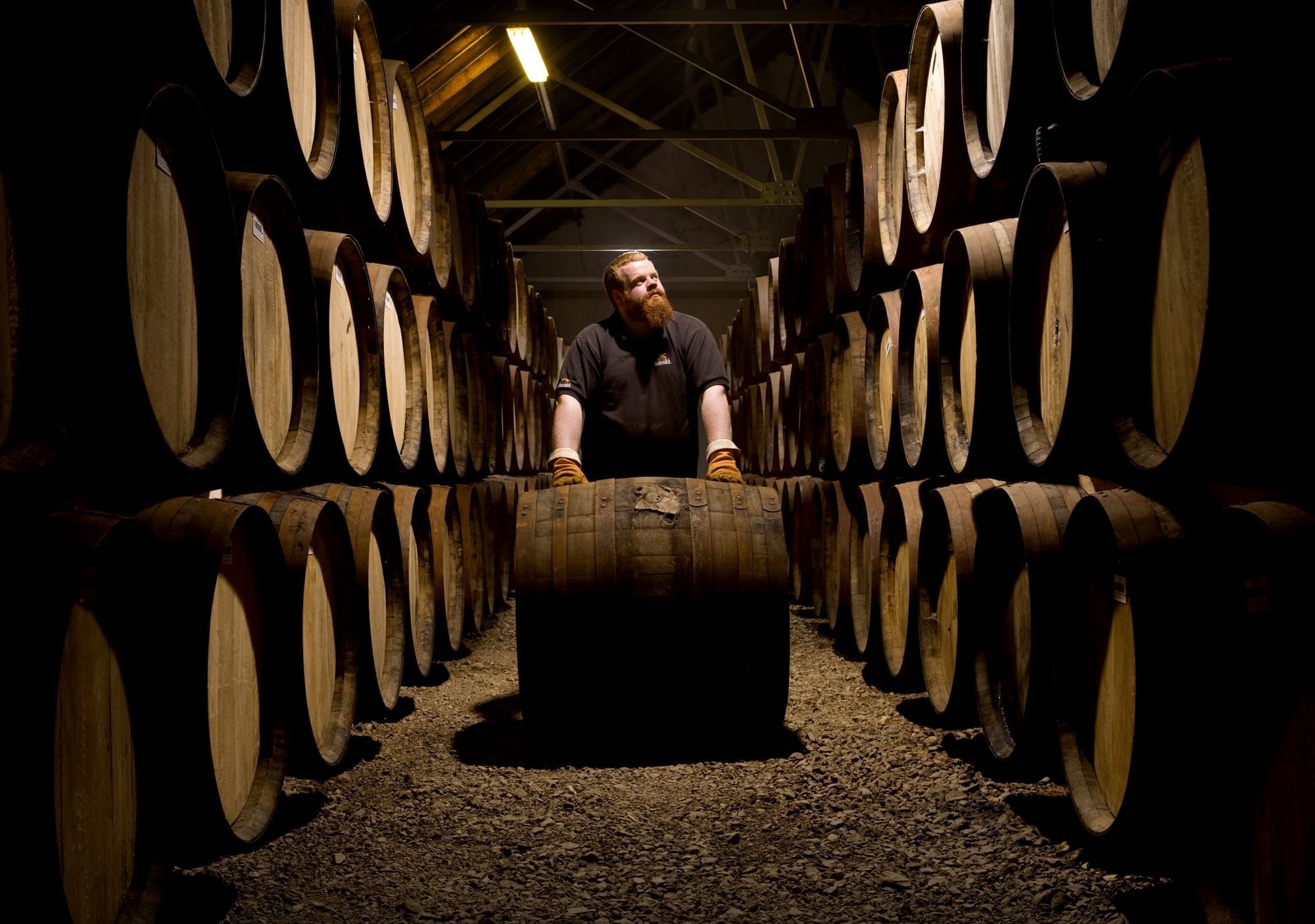 A man walking in the Glenfiddich Solera whisky production area at The Londoner