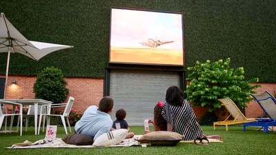 A family watching a movie in a courtyard at The Fredonia Hotel
