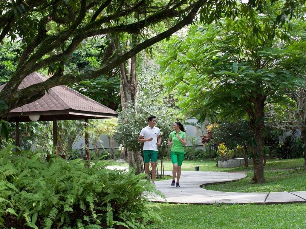 A couple walking in the garden at Royal Ambarrukmo Yogyyakarta