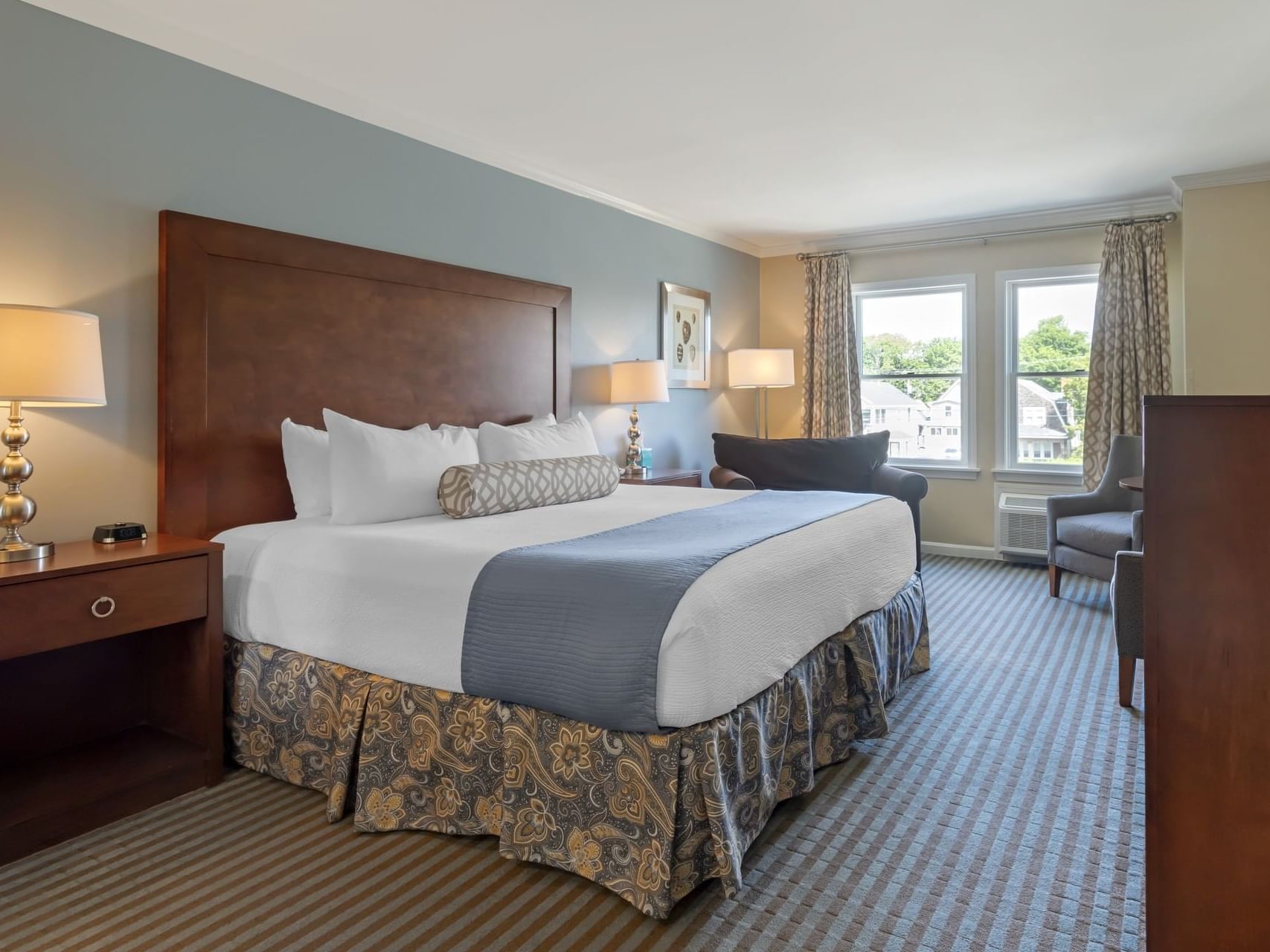 Nightstands & seating area by the bed in Deluxe King Room at Union Bluff Hotel