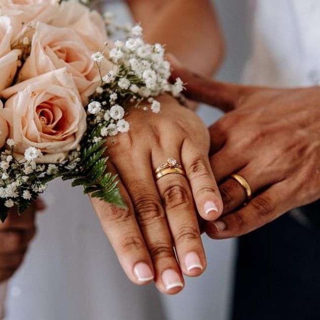 Bride wearing both engagement ring and wedding ring on her finger on wedding day