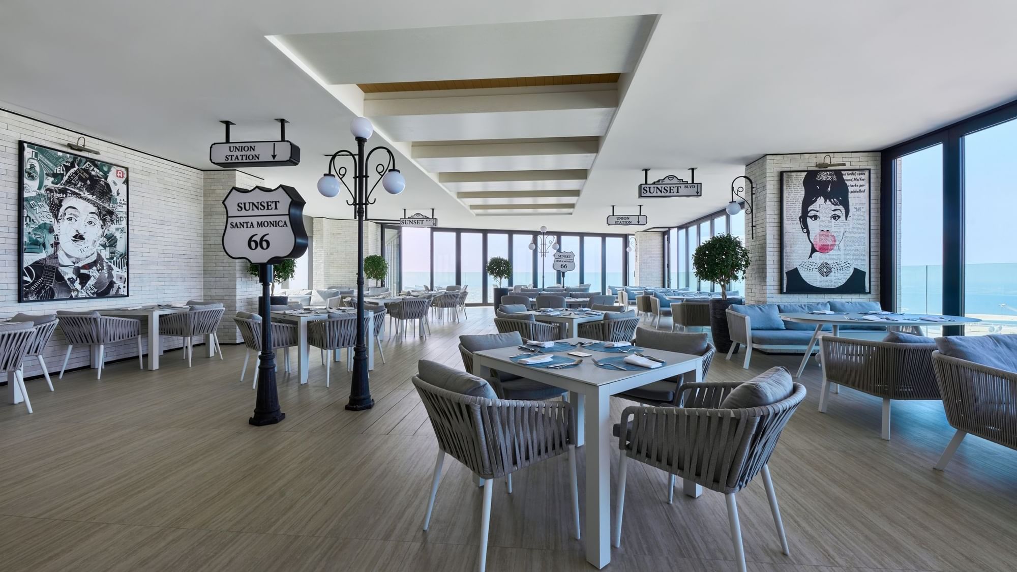 Bright and stylish dining area with rope weave chairs and city views at Malibu Sky Lounge, Paramount Hotel Midtown