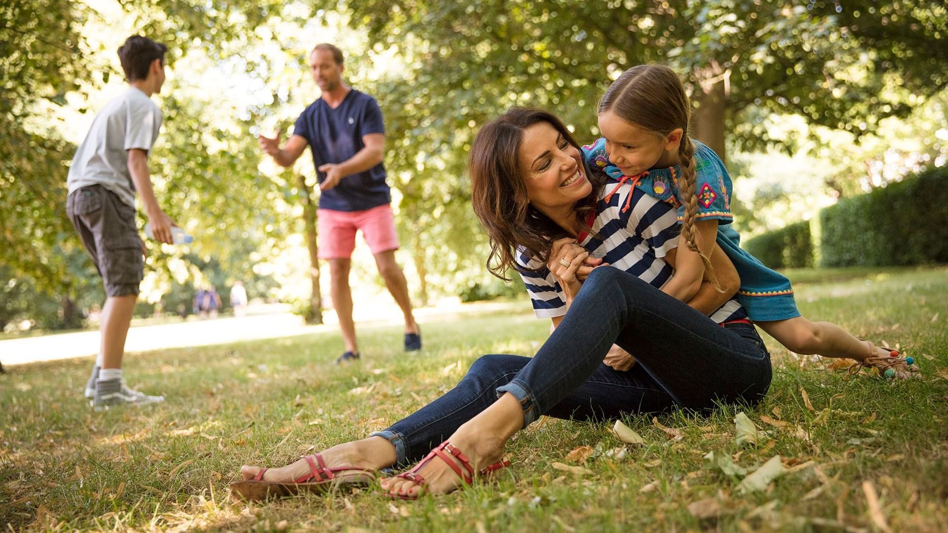 Family enjoying in a garden near The Clermont Victoria