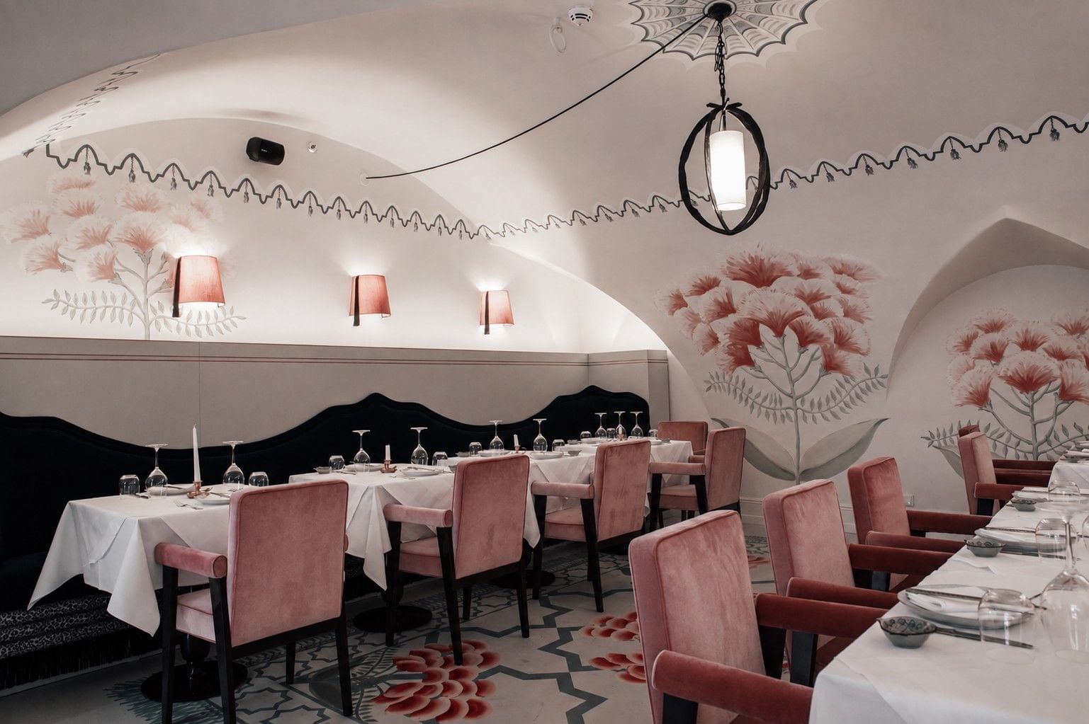 Salon Oriental at Hotel THE LEO GRAND with elegantly set tables, pink velvet chairs and floral wall art