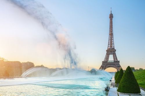 Eiffel Tower behind fountain with water jets at sunset from Warwick Corporate