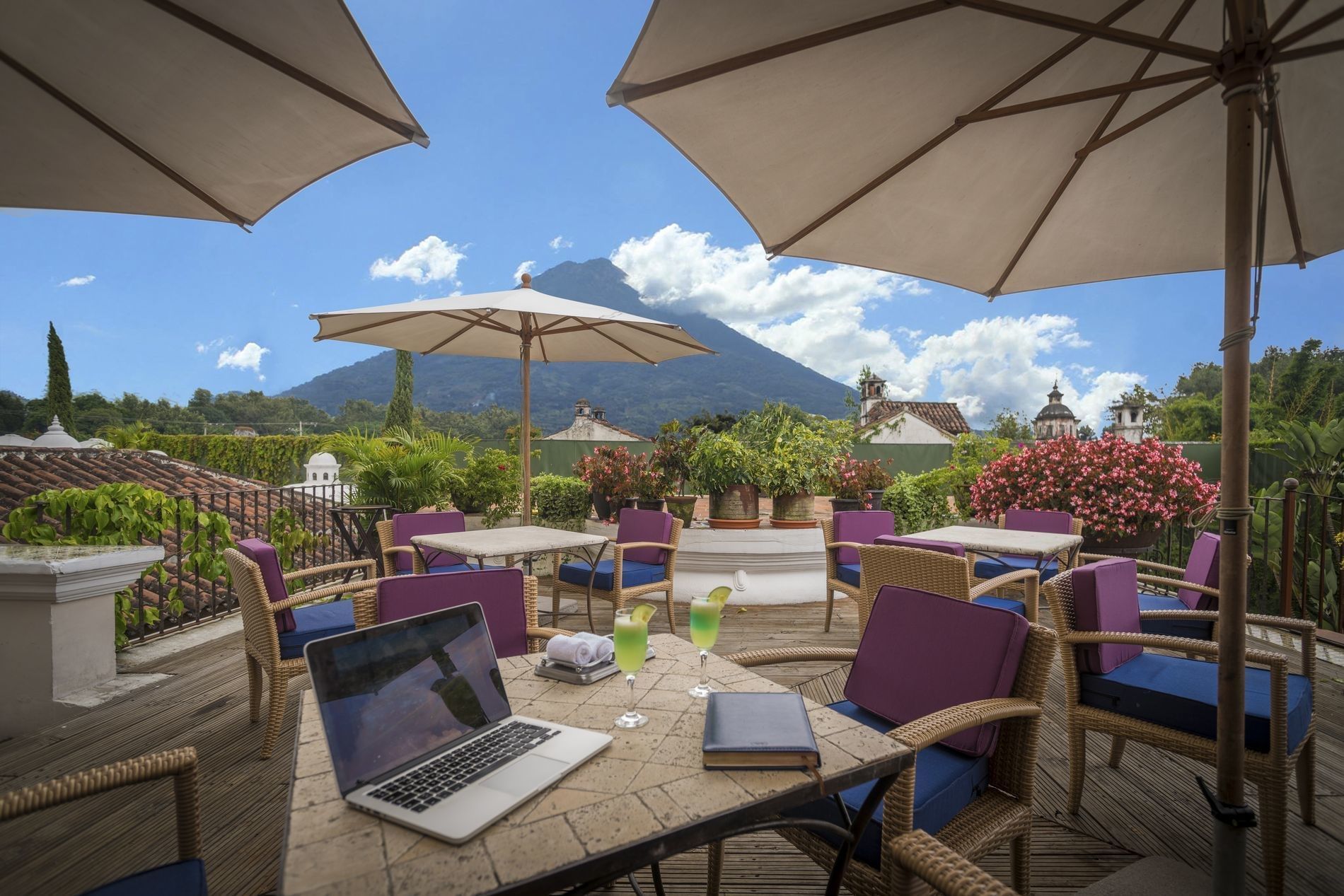 Lounge area with patio umbrellas on The Rooftop at Pensativo House Hotel
