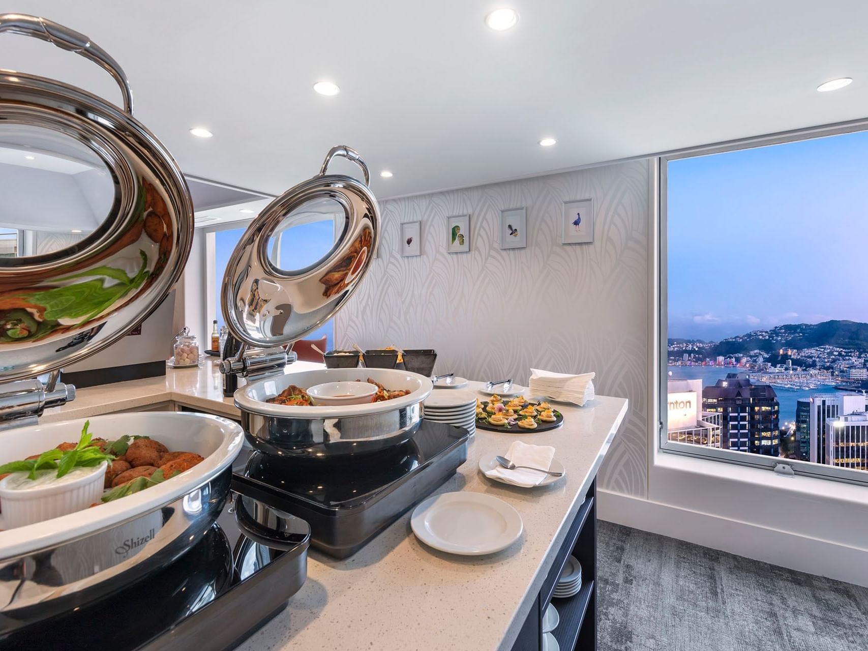 Open buffet display with a city view at James Cook Grand Chancellor