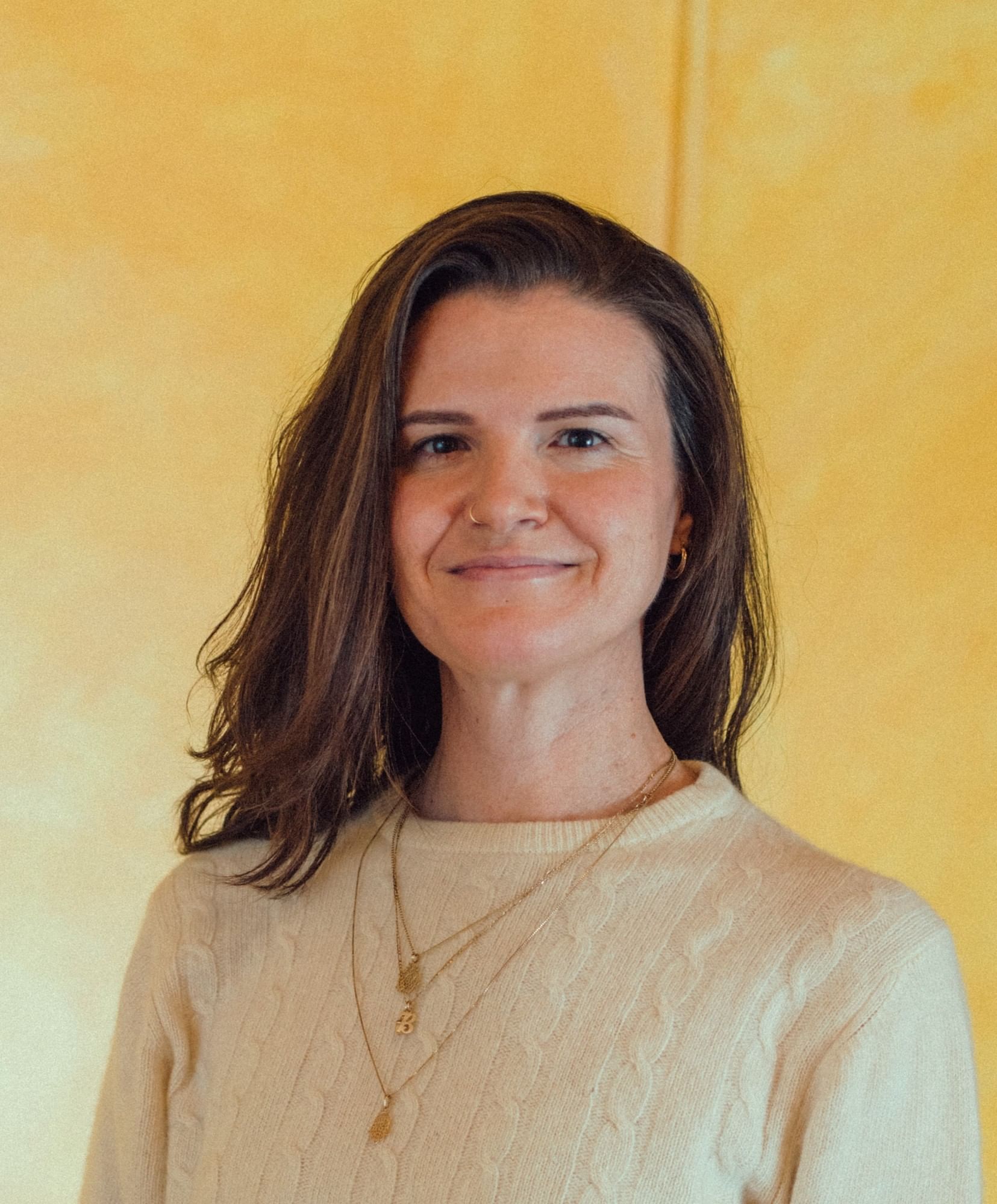 Woman with brown hair smiling.