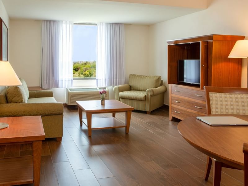 Living area of Junior Suite with TV at Fiesta Inn