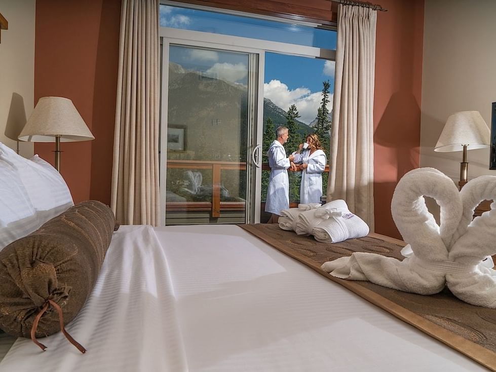 A couple on the balcony in a suite at Clique Hotels & Resorts
