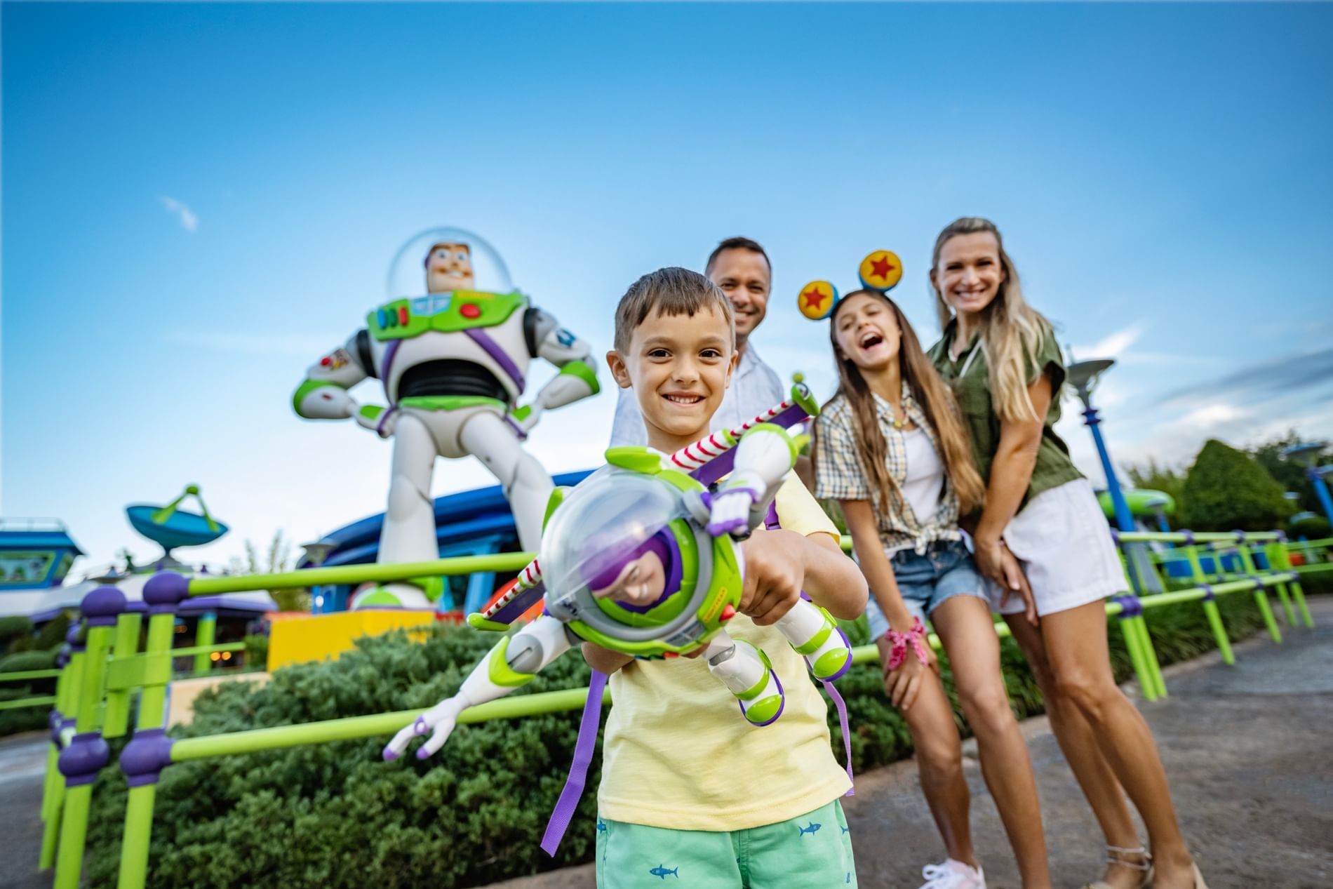 Family posing with a Buzz Lightyear character at theme park near Lake Buena Vista Resort Village & Spa