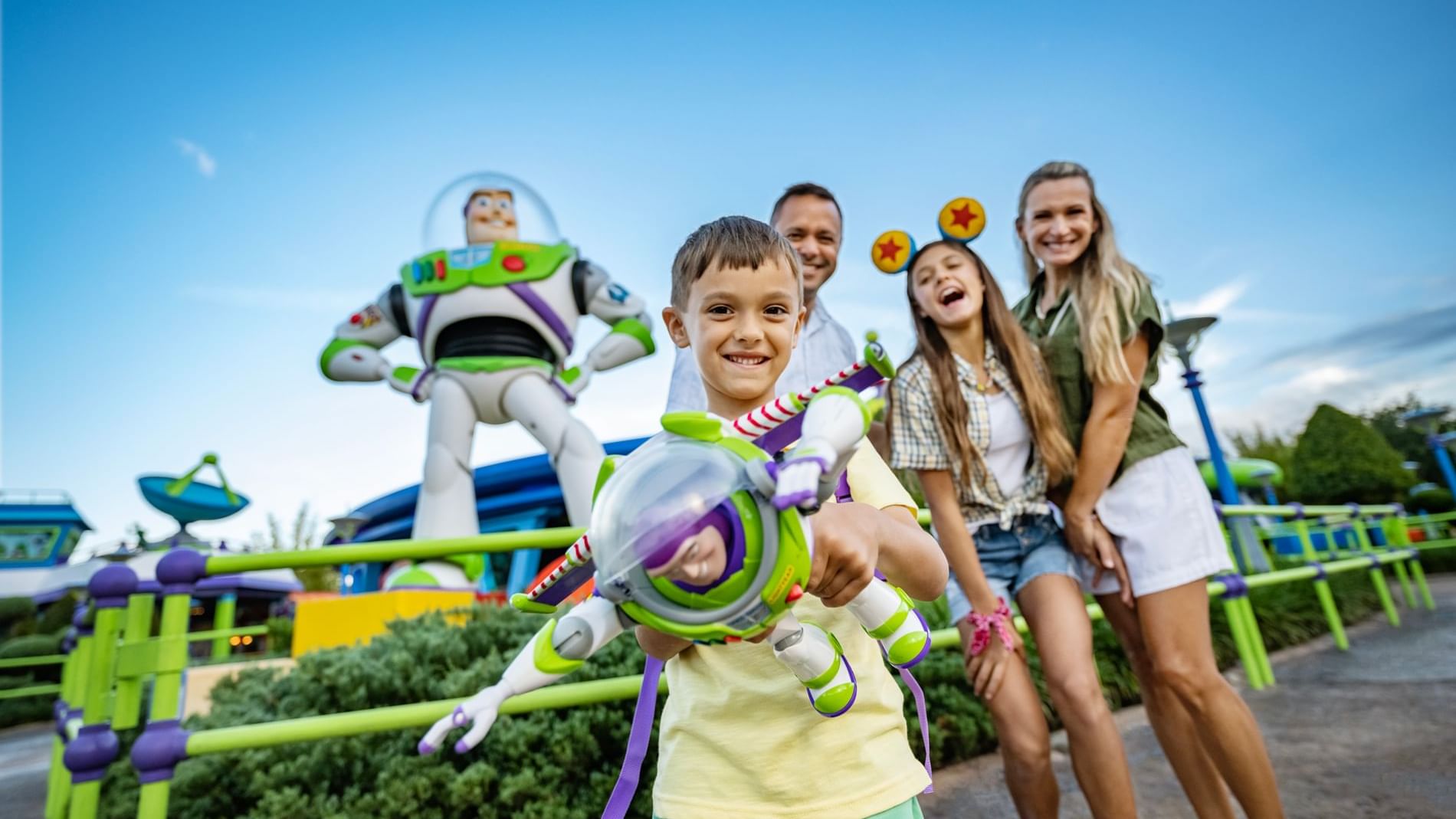 Family posing with a Buzz Lightyear character at theme park near Lake Buena Vista Resort Village & Spa