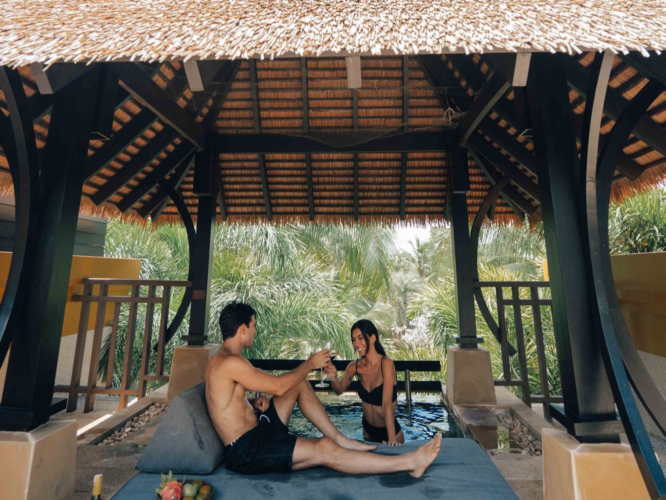 Romantic couple enjoying a sweet moment by the private rooftop plunge pool at the Penthouse Villa in a Phuket honeymoon resort