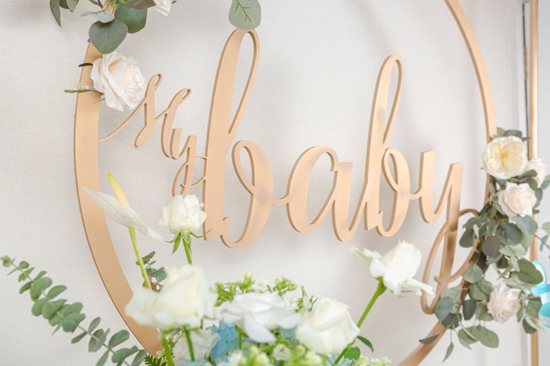 Decorative baby shower setup featuring white and blue flowers at Park Hyatt Saigon