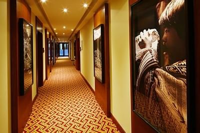 Interior of the hallway with large pictures hung at Hotel Sumaq