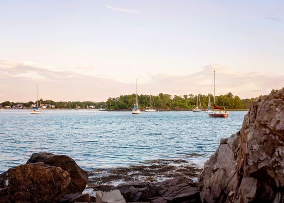 Landscape view of boulders & yachts in a distant near Sebasco Harbor Resort