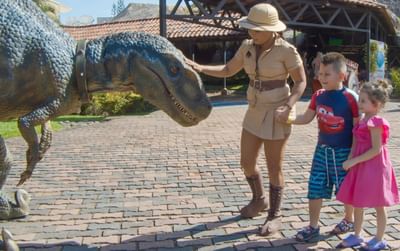 Family watching Jurassic animals statue at Fiesta Resort