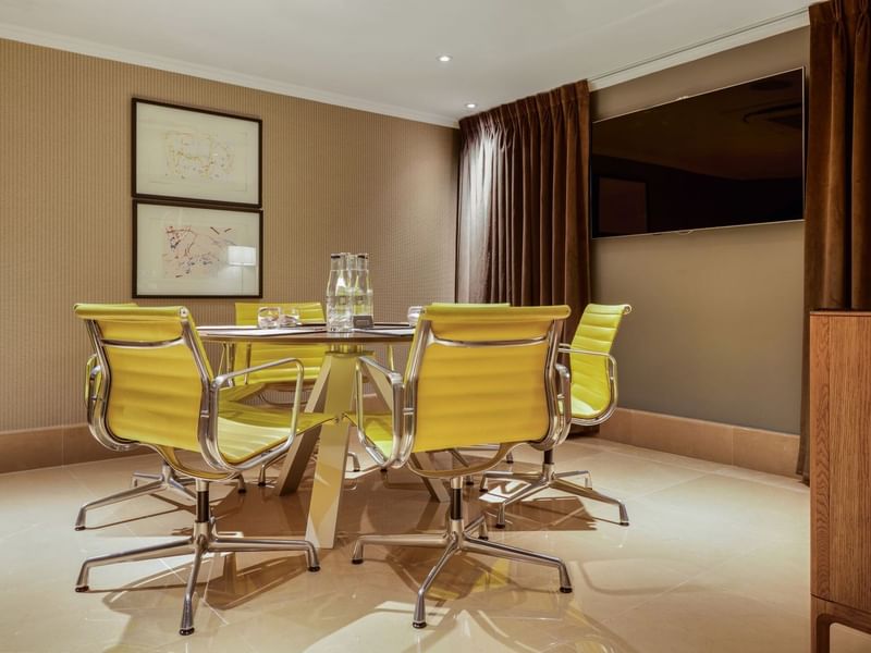 Private Suite with boardroom set up and unique artwork at The May Fair Hotel