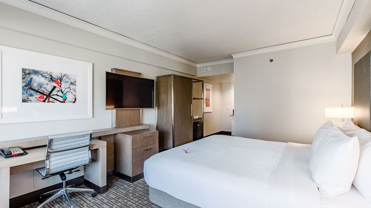 Accessible hotel guestroom with king bed, TV, and desk