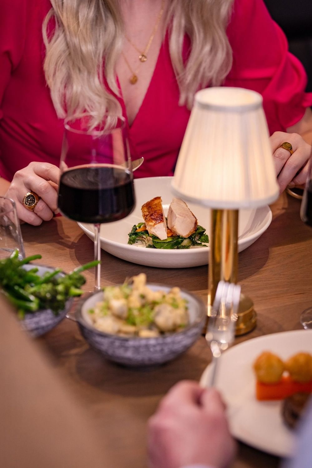Red wine and gourmet dishes at an elegant dining table at The Bedford Hotel Belfast