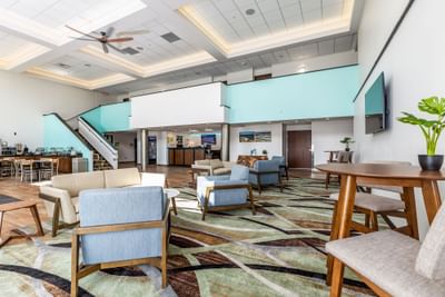Modern lobby featuring stylish seating, a staircase, and a reception area with soft lighting at Off Shore Resort