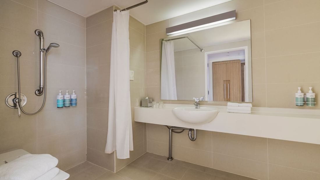 Bathroom with vanity, shower area, and amenities in Superior Accessible Room at Novotel Sydney Olympic Park