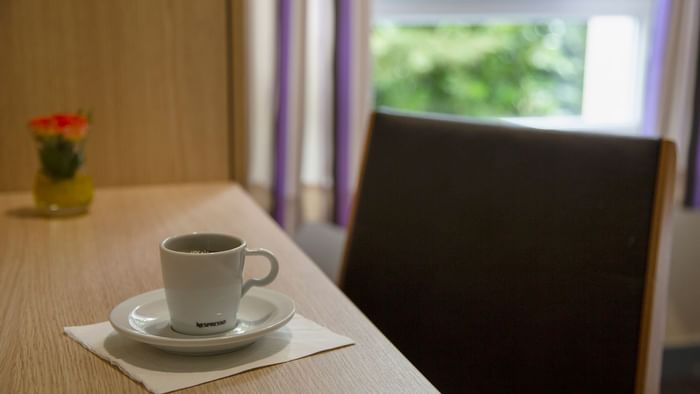 Cup of coffee kept on the desk at Le Clos de l'Orgerie
