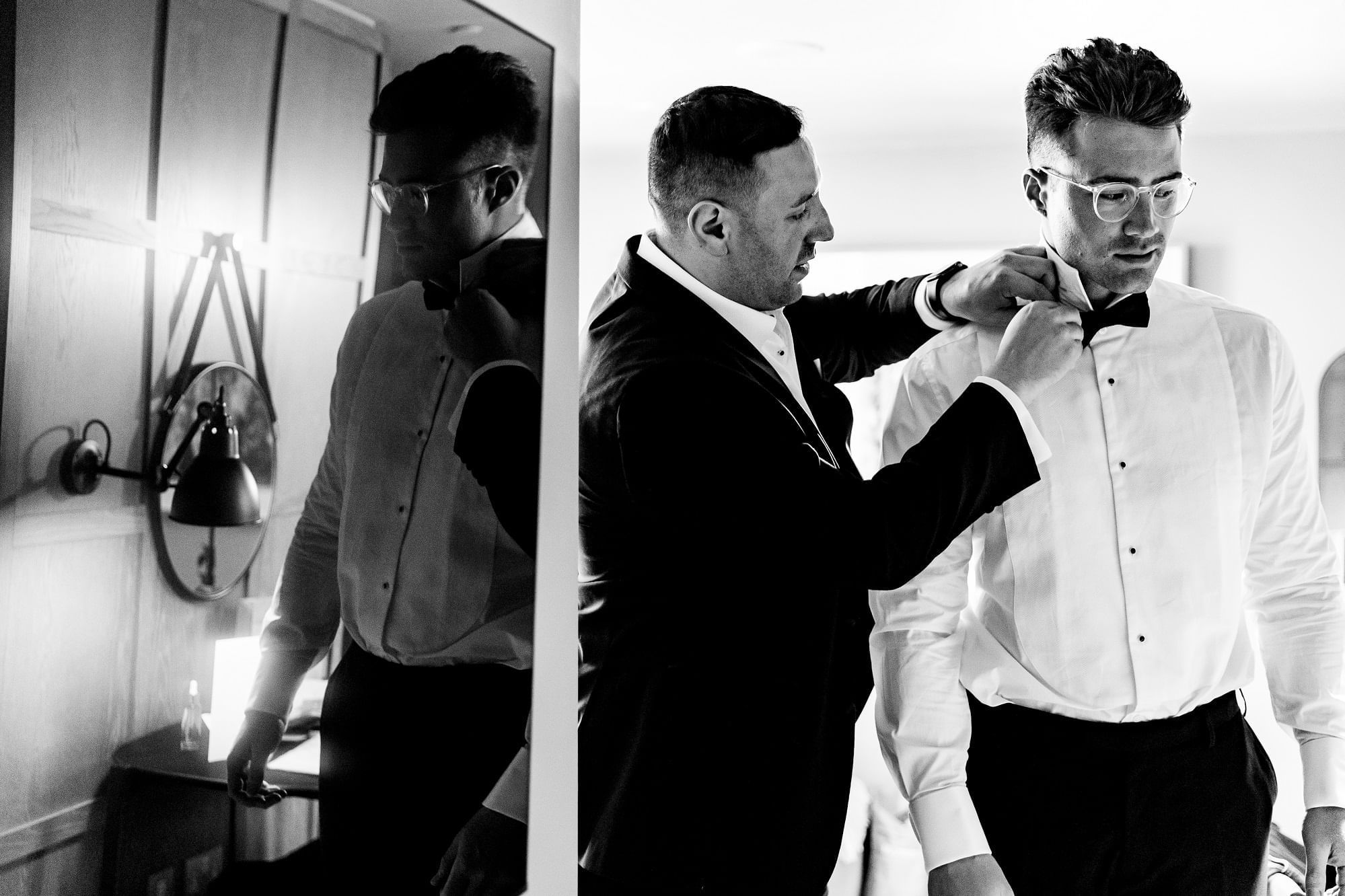 Black & white image of a man assisting another man in tying his tie at The Londoner Hotel