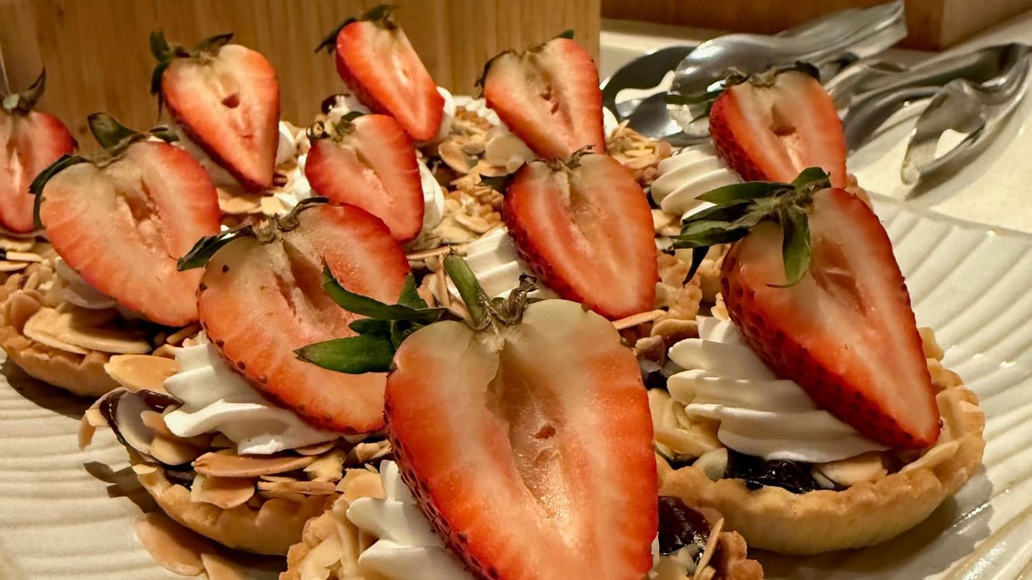 Tarts with cream, strawberries, and almonds on a plate at Warwick Paradise Island - Bahamas, Nassau.