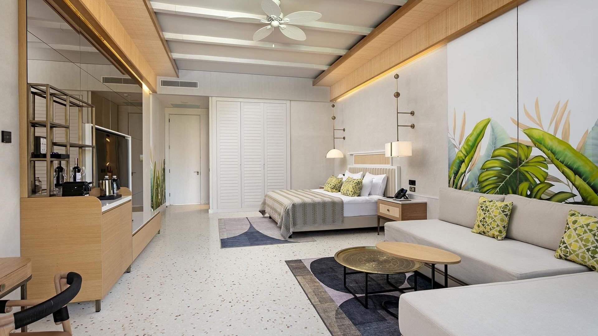 Spacious TV & seating area by the bed in Lagoon Beach Swim-up Room at Cullinan Belek