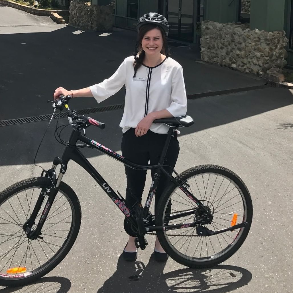 A lady holding a bike near Cradle Mountain Hotel