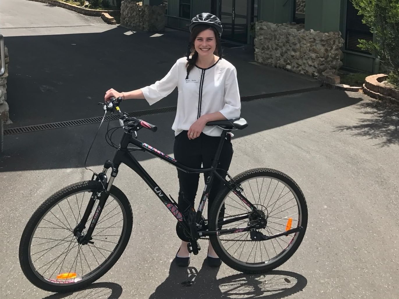 A lady holding a bike near Cradle Mountain Hotel