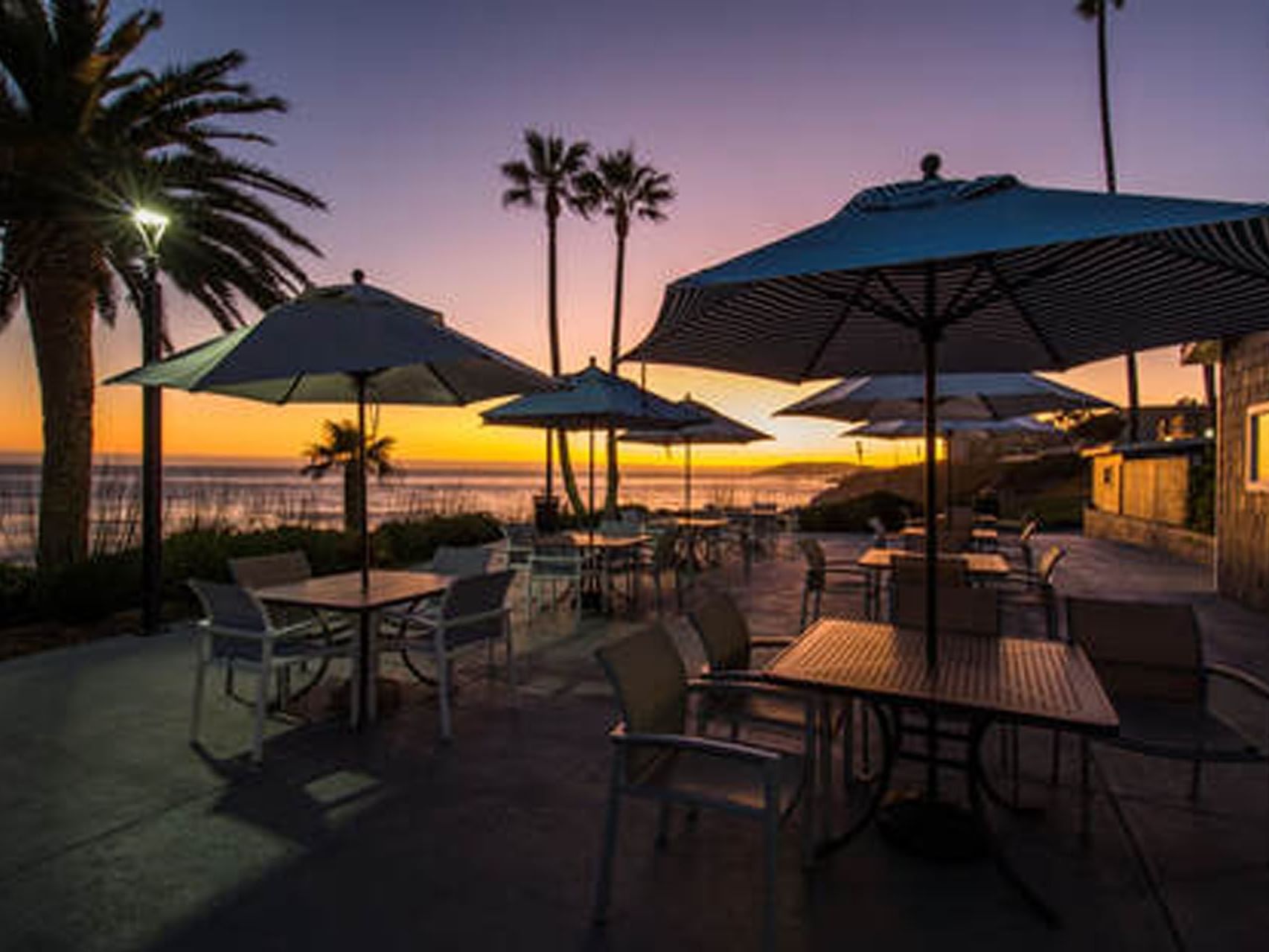 Oceanfront Terrace at sunset with a cozy seating area in SeaCrest Oceanfront Hotel Pismo Beach
