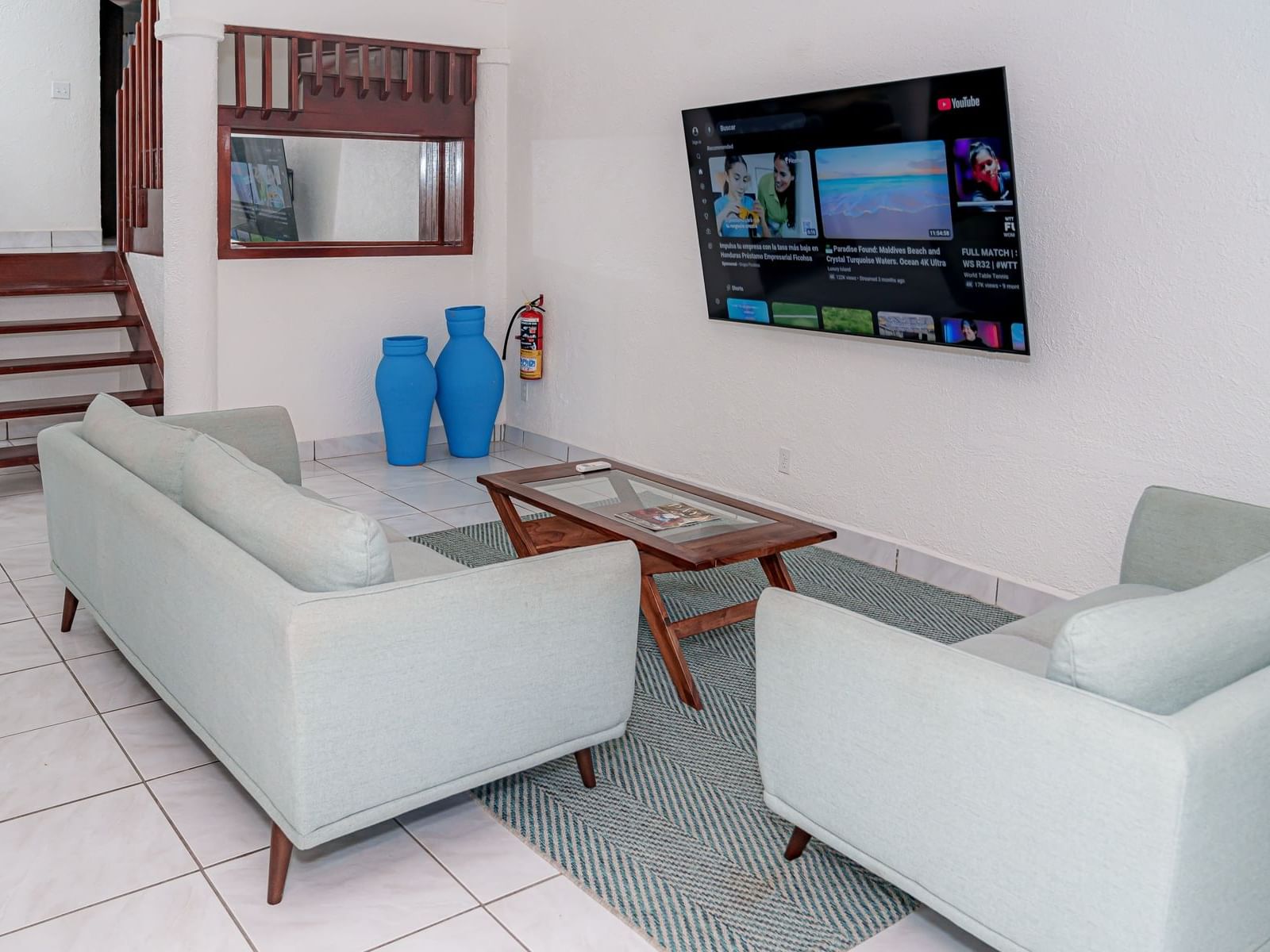 Lounge area with a TV by the stairway in Garden Villa at Paradise Beach Hotel