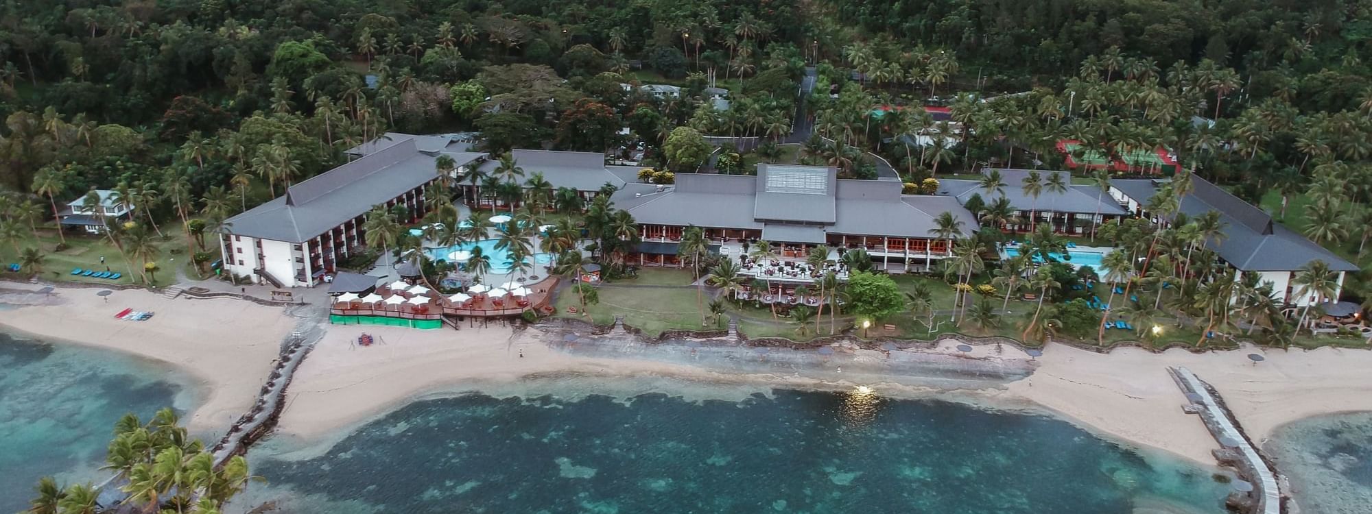 Aerial shot of Warwick Resort in Fiji surrounded by the sea and lush greenery