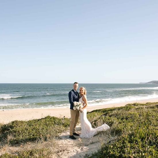 Wedding couple taking photos by the sea near Pullman Magenta Shores