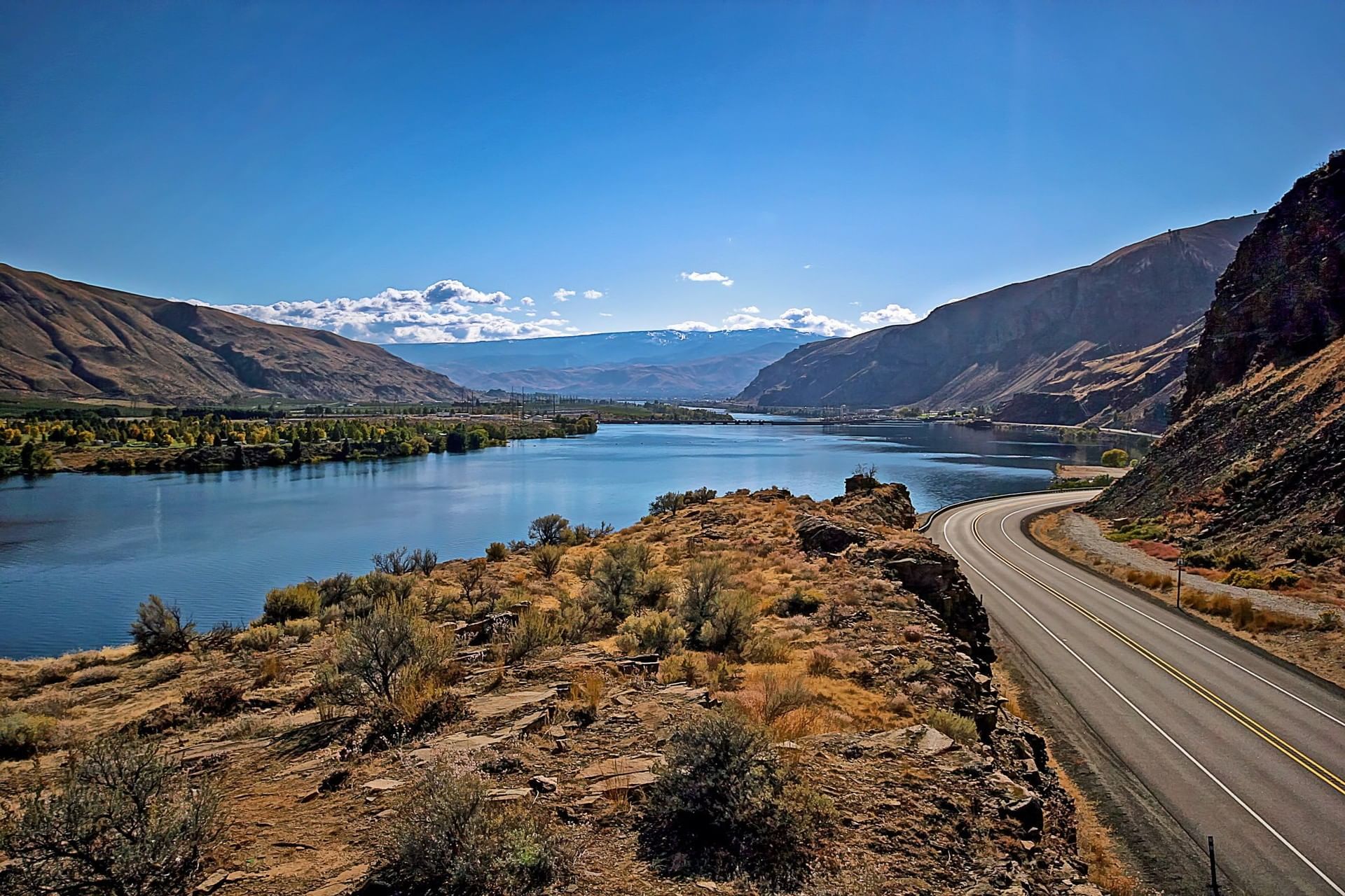 Winding road through mountains and lake