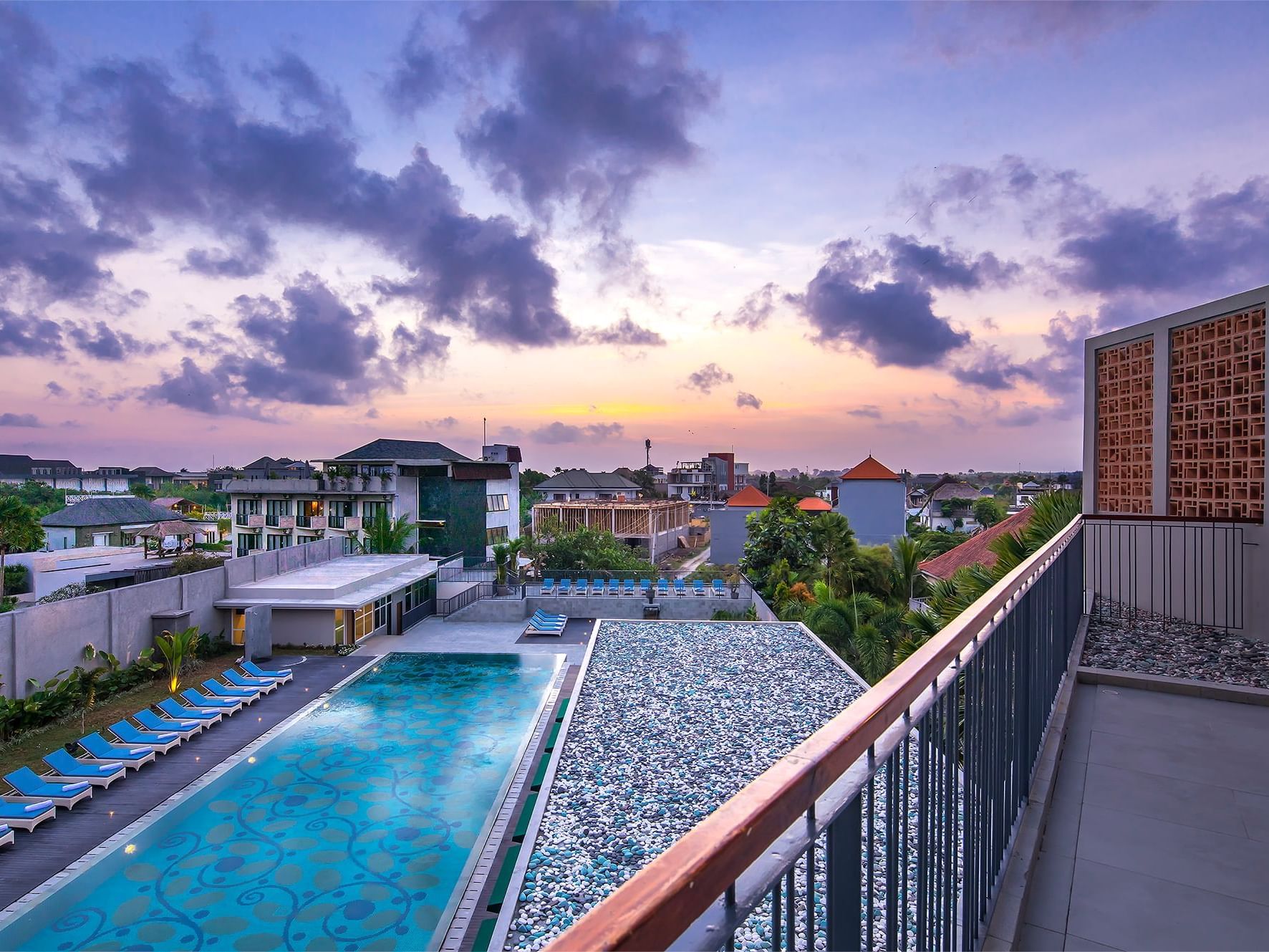 Outdoor pool & city view from balcony at Eastin Ashta Resort Canggu