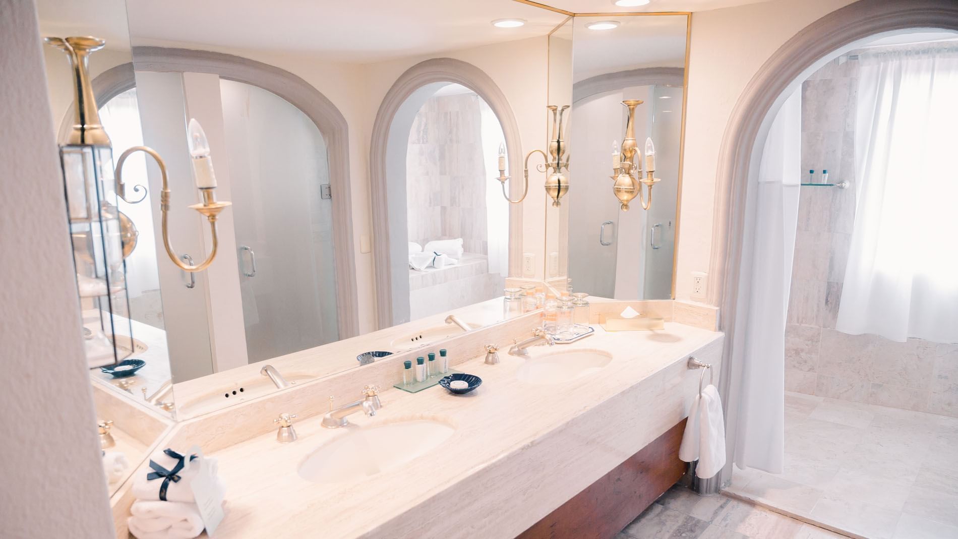 King Presidential Suite luxurious bathroom with a large mirror, two sinks, and a shower area at Quinta Real Zacatecas