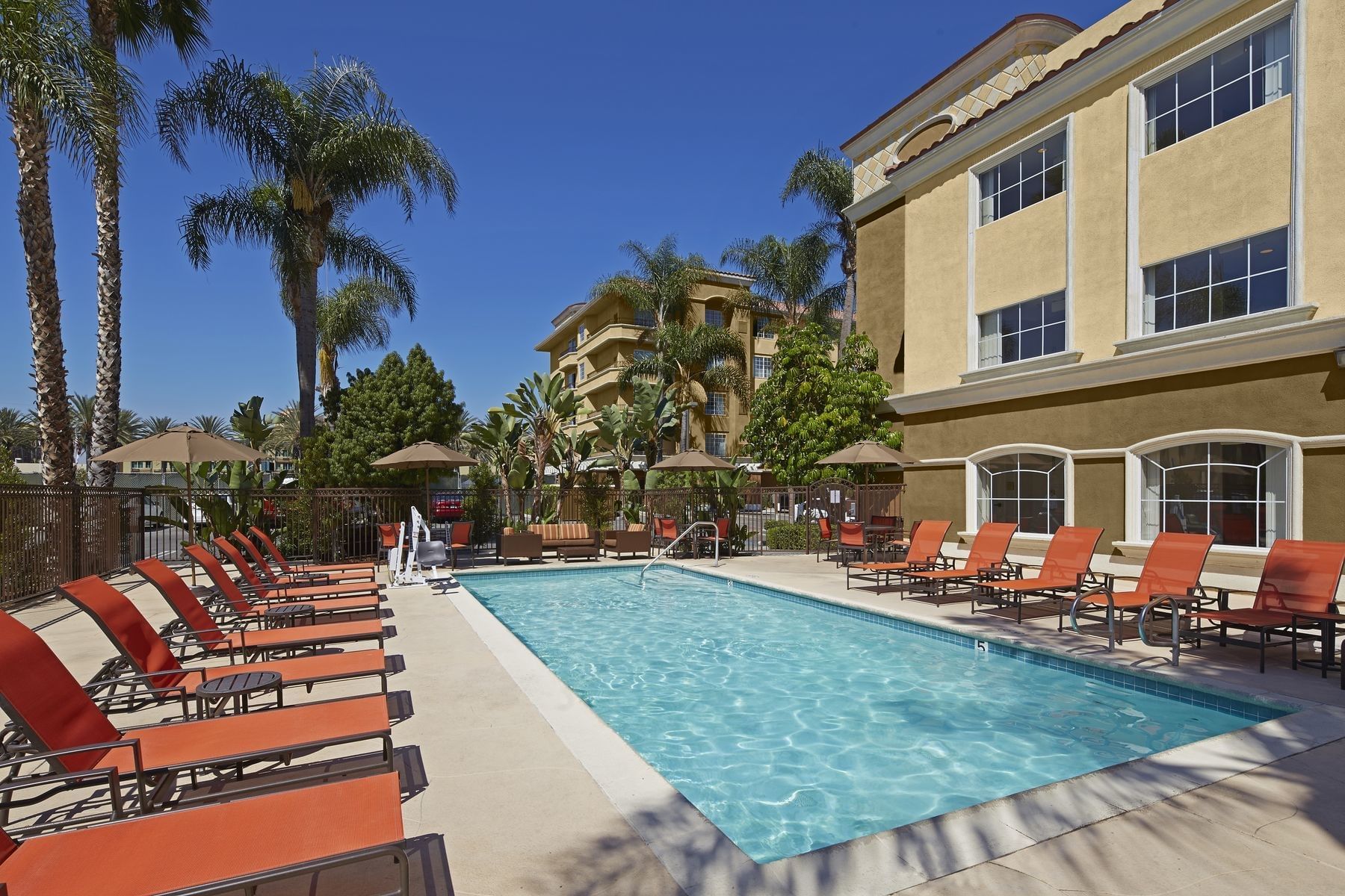 Outdoor pool area with pool beds at Anaheim Portofino Inn