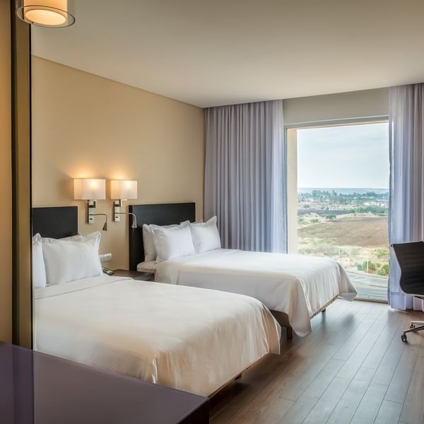 Twin beds in Superior Room with view at Fiesta Inn