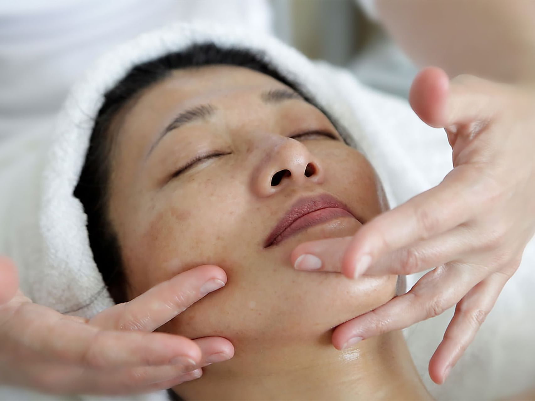 Lady having a Signature Herbal Facial at August Moon Spa