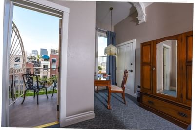 Work desk & balcony lounge in a room at Horton Grand Hotel